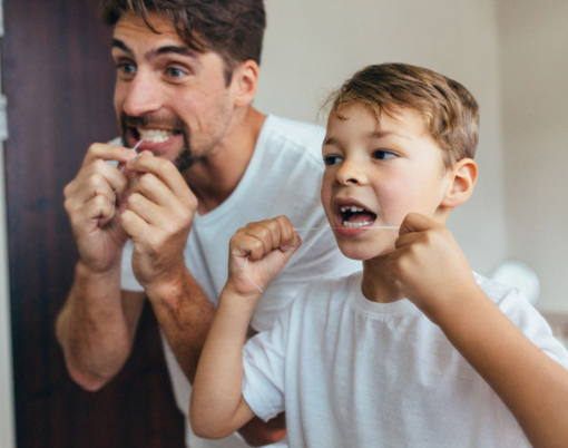 Father and Son Flossing Their Teeth